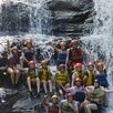 Groepsfoto bij waterval, raften